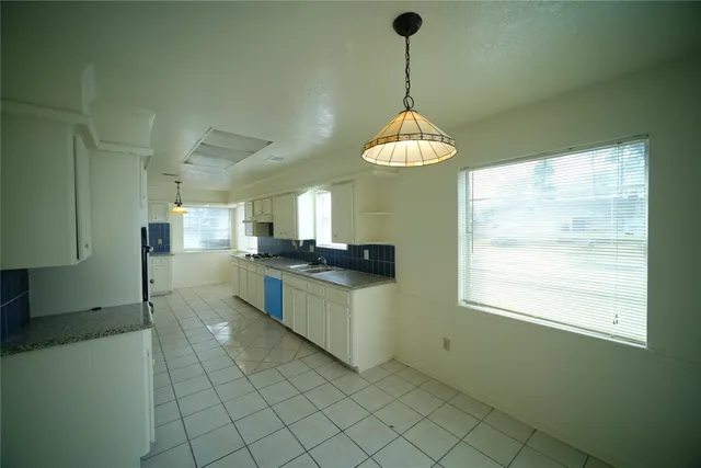 a kitchen with stainless steel appliances a stove a refrigerator and a sink