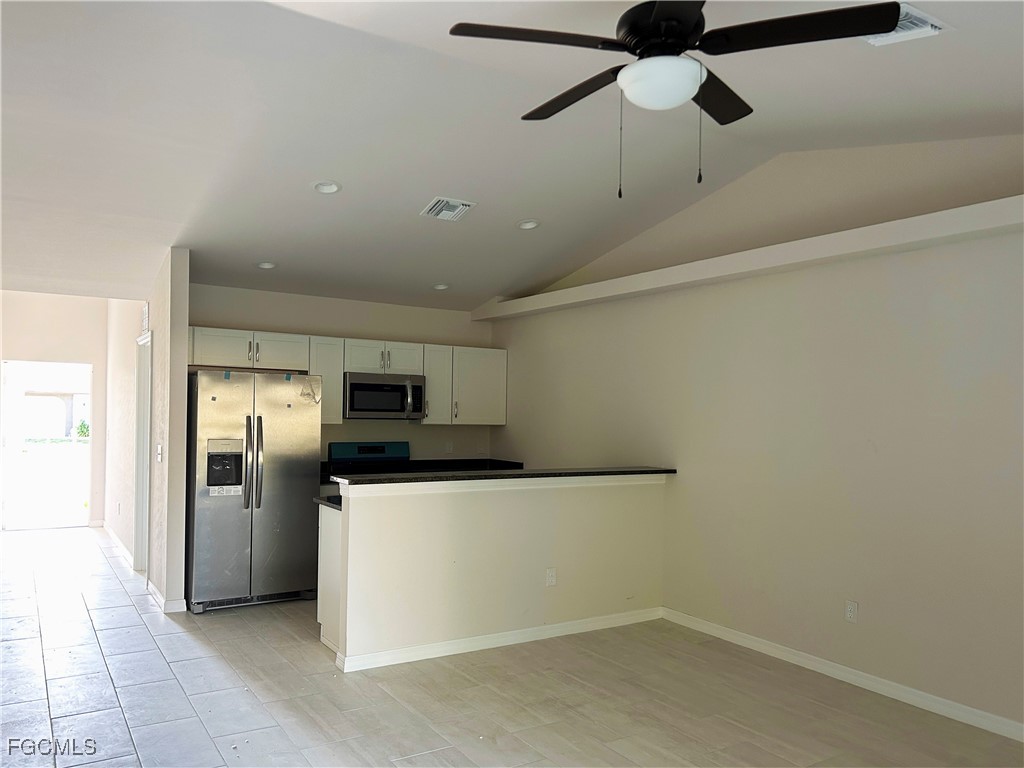 3610 Southwest 17th Avenue Cape Coral, FL 33914 - Photo 2 of 10 a kitchen with stainless steel appliances a refrigerator and a microwave
