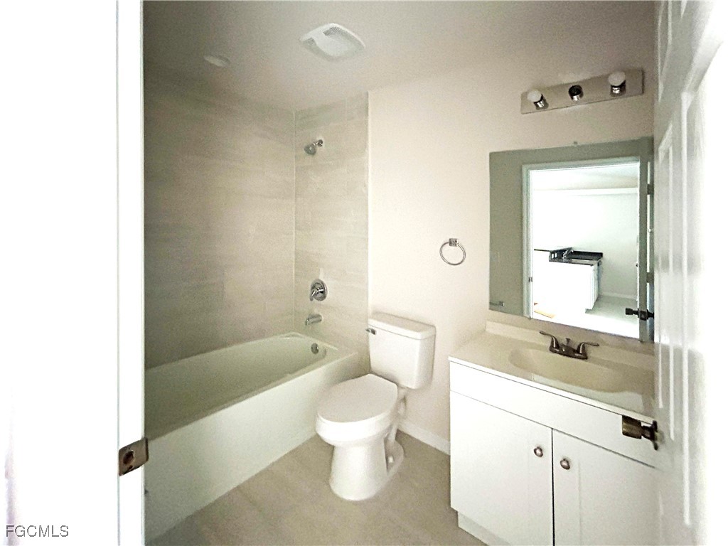 3610 Southwest 17th Avenue Cape Coral, FL 33914 - Photo 5 of 10 a bathroom with a granite countertop toilet a sink and a bathtub