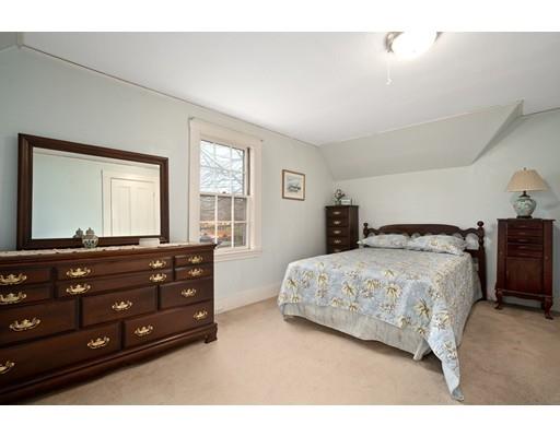 535 Maple Street Danvers, MA 01923 - Photo 15 of 23 a bedroom with a bed and a large mirror