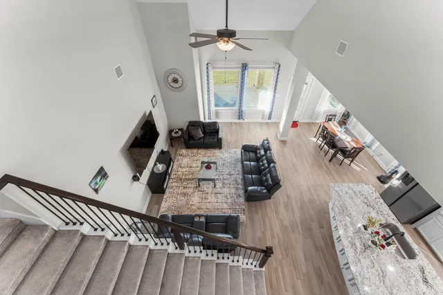 a living room with furniture and a chandelier