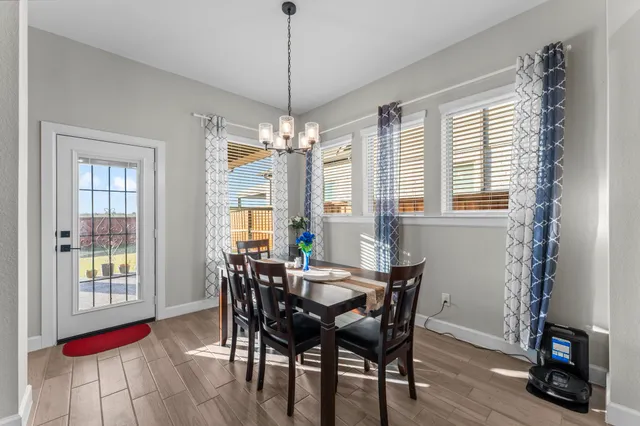 a living room with furniture a clock and a chandelier