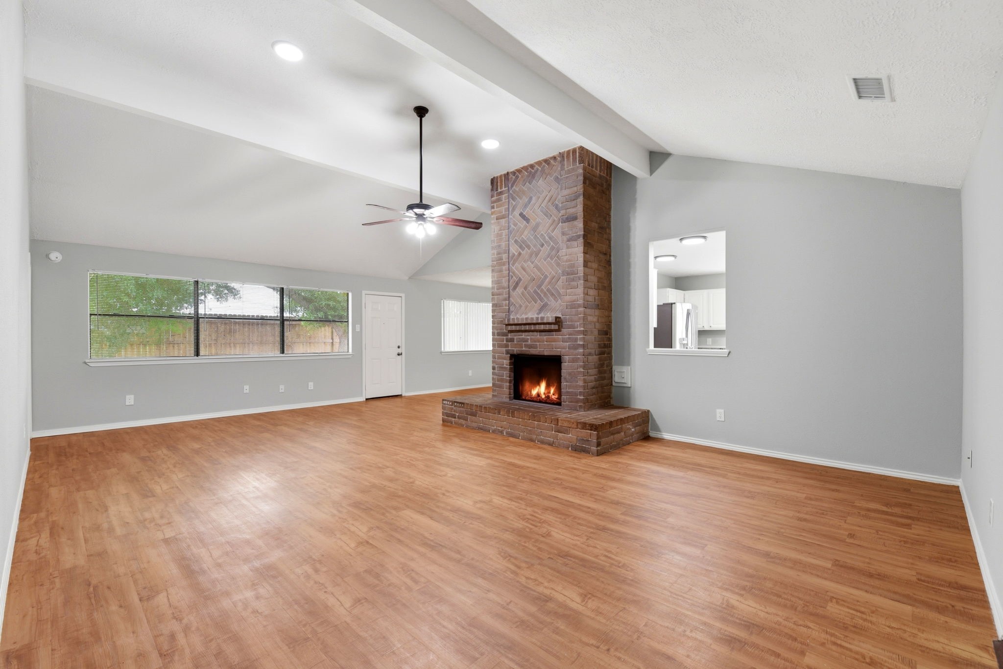 21330 Golden Dove Drive Spring, TX 77388 - Photo 4 of 29 The absolute heart of the home! This expansive, light-filled living area features striking vaulted ceilings and a stunning floor-to-ceiling brick gas fireplace.