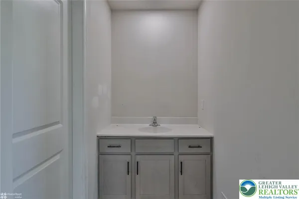 a bathroom with a sink vanity and a mirror