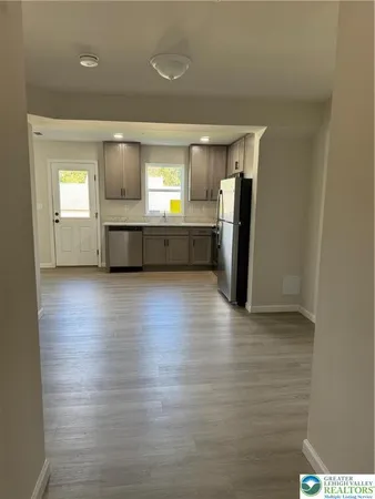 a view of a kitchen with a refrigerator and a window