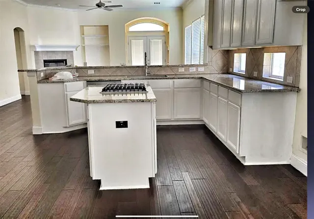 a kitchen with stainless steel appliances granite countertop a sink stove and wooden floor