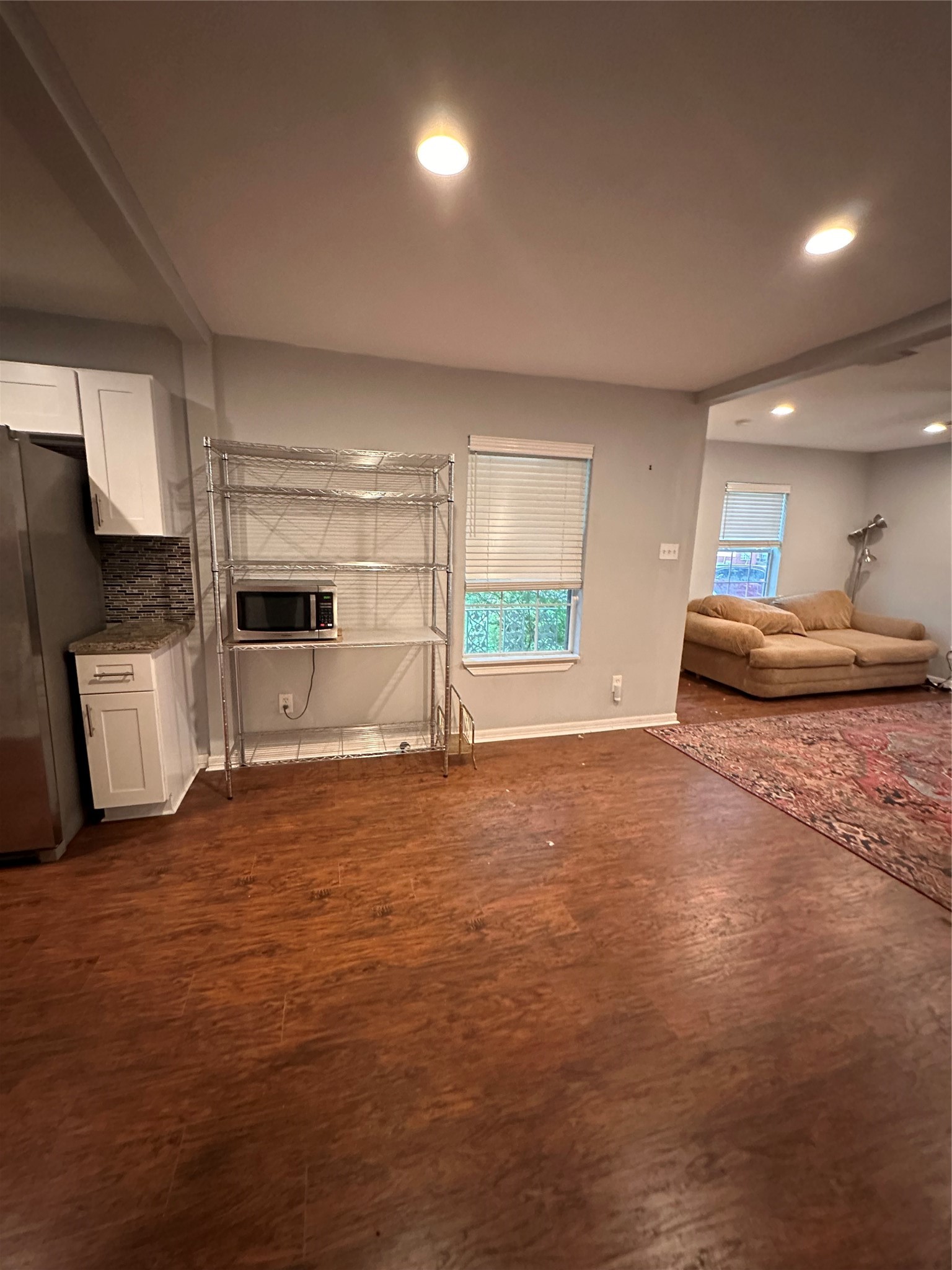 4802 Eppes Street Houston, TX 77021 - Photo 33 of 34 a large room with kitchen island wooden floors and stainless steel appliances
