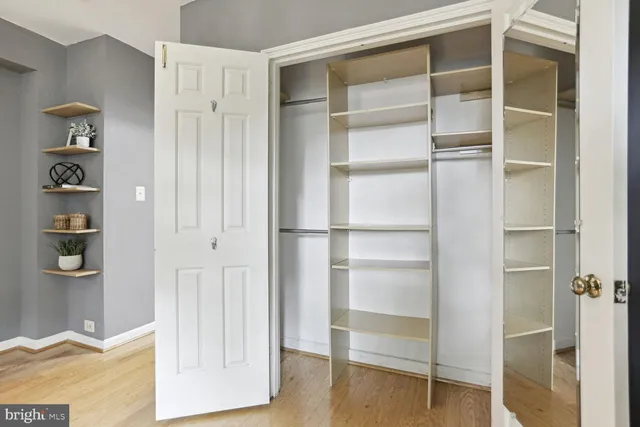 a view of walk in closet with empty racks