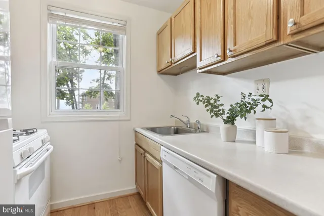 a kitchen with a sink cabinets and a window