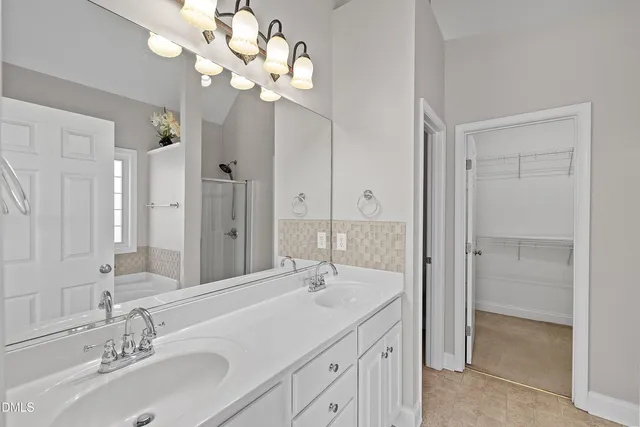 a bathroom with a sink vanity granite and a mirror