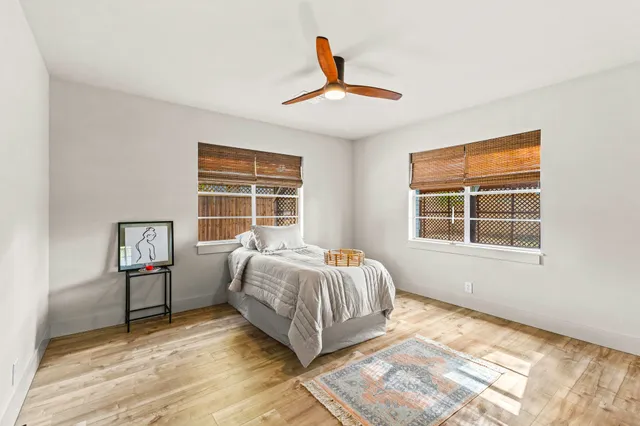a spacious bedroom with a bed and a window