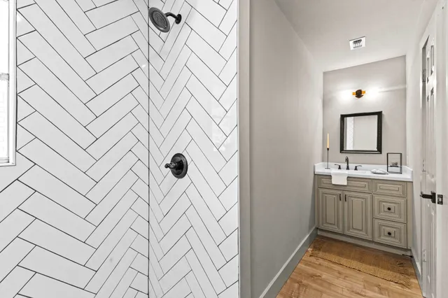 a bathroom with a sink a mirror and a shower