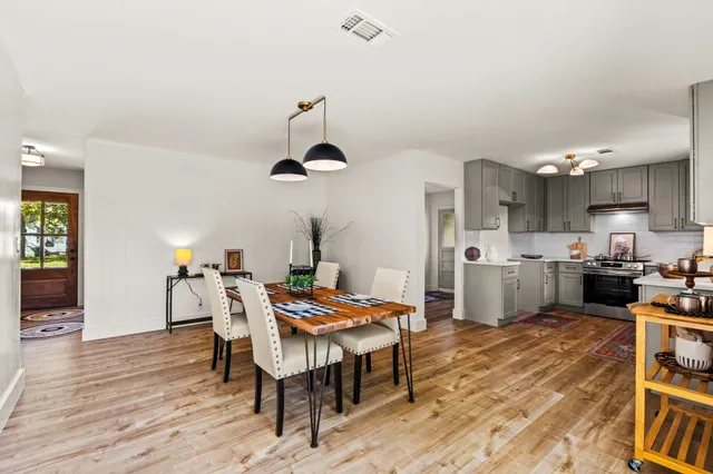 a view of a dining room with furniture and wooden floor