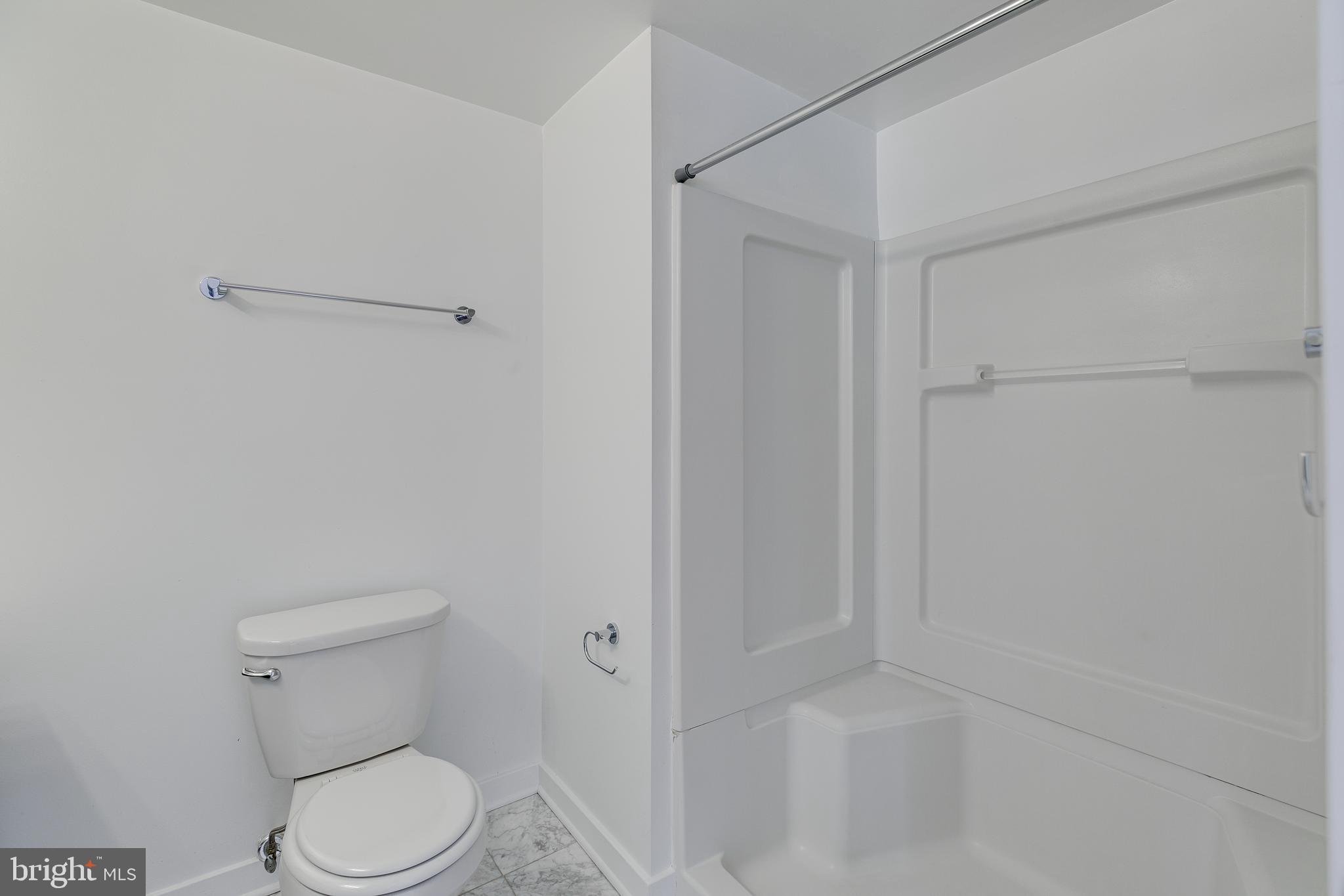 220 West George Street, Unit 224 Philadelphia, PA 19123 - Photo 18 of 56 a white toilet sitting next to a shower