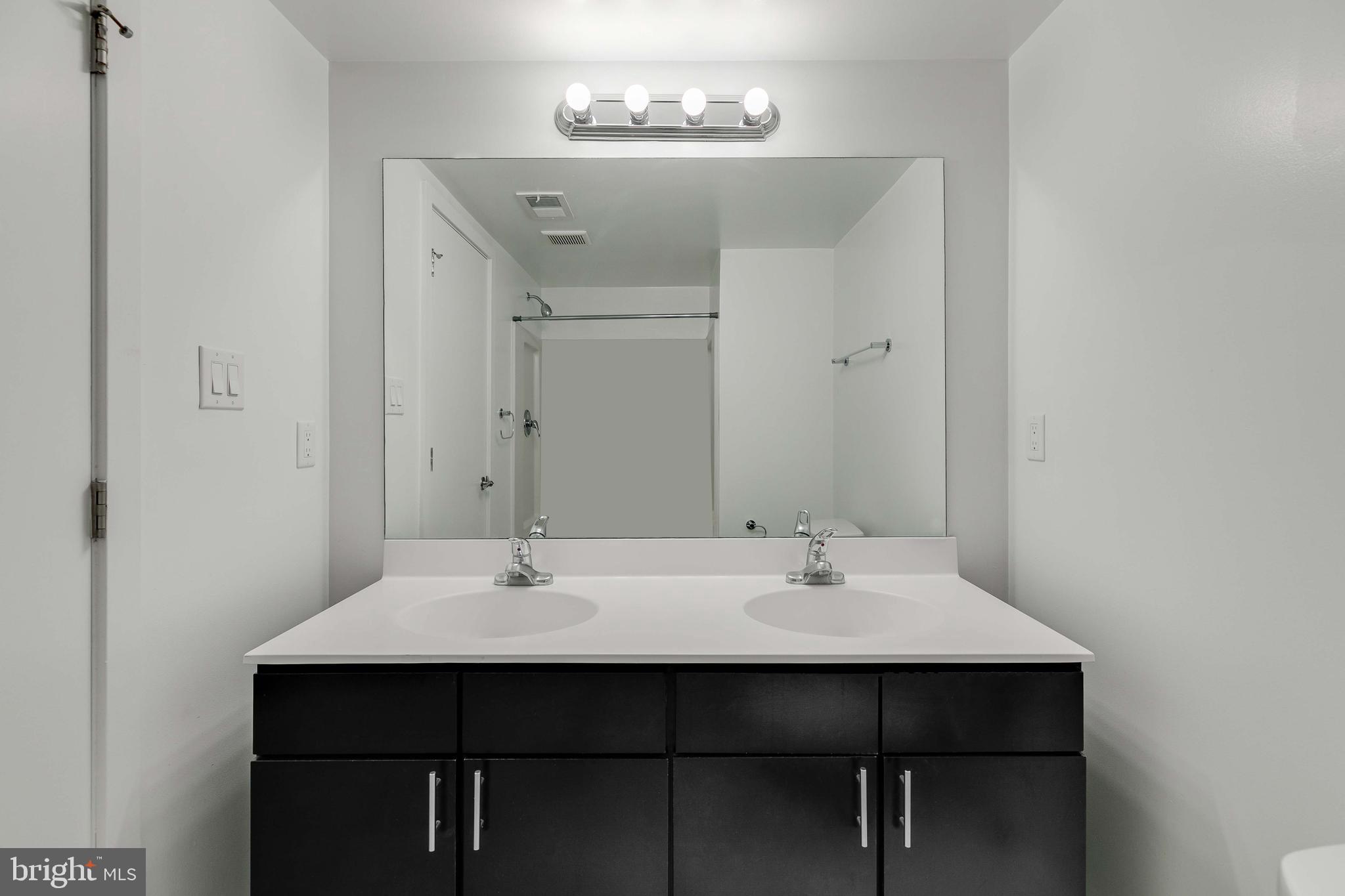 220 West George Street, Unit 224 Philadelphia, PA 19123 - Photo 19 of 56 a sink with a mirror