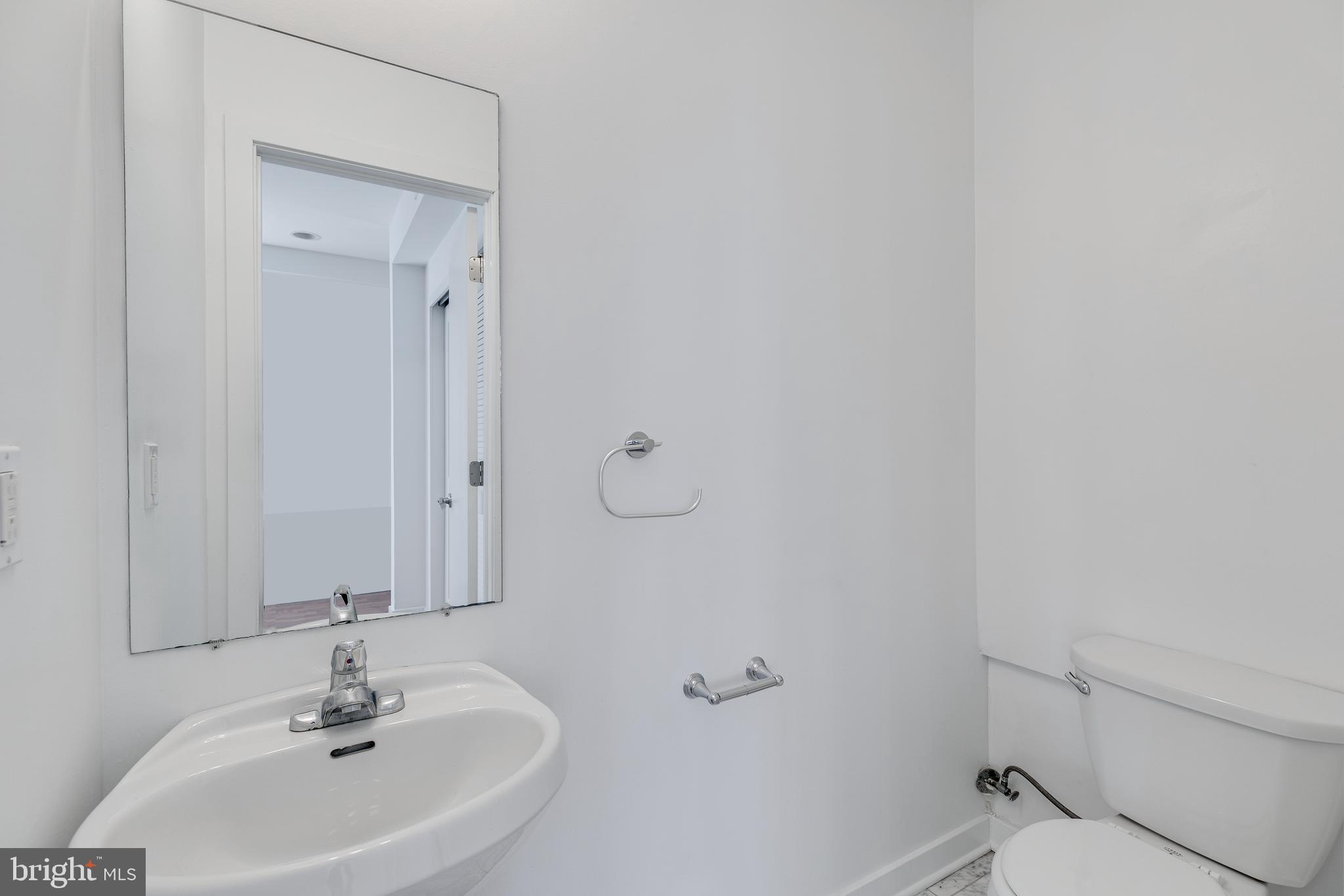 220 West George Street, Unit 224 Philadelphia, PA 19123 - Photo 20 of 56 a bathroom with a sink a toilet and a mirror