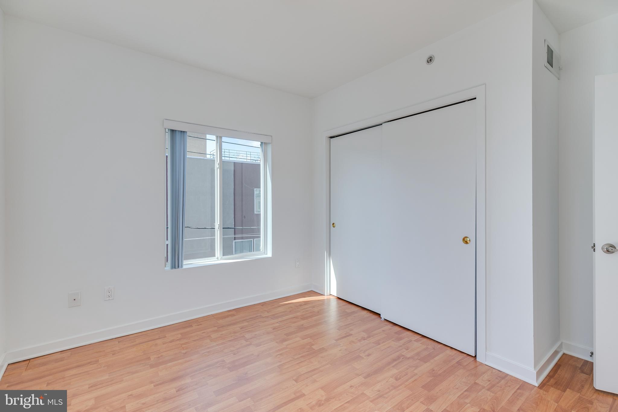 220 West George Street, Unit 224 Philadelphia, PA 19123 - Photo 25 of 56 a view of an empty room with wooden floor and a window