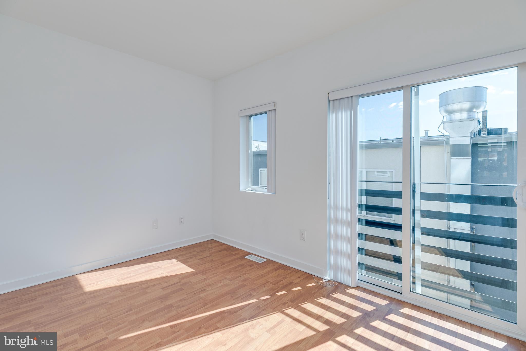 220 West George Street, Unit 224 Philadelphia, PA 19123 - Photo 27 of 56 a view of wooden floor and windows in a room