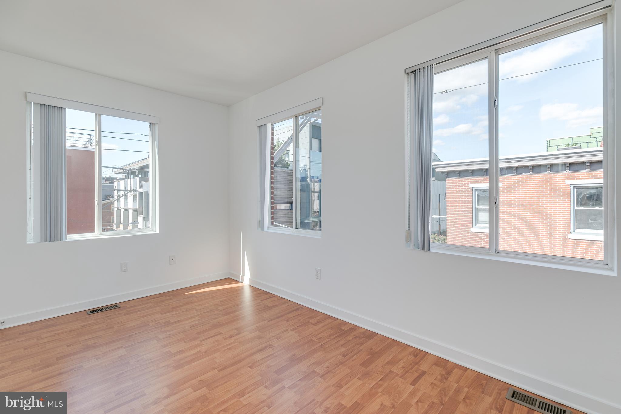220 West George Street, Unit 224 Philadelphia, PA 19123 - Photo 30 of 56 a view of an empty room with wooden floor and a window