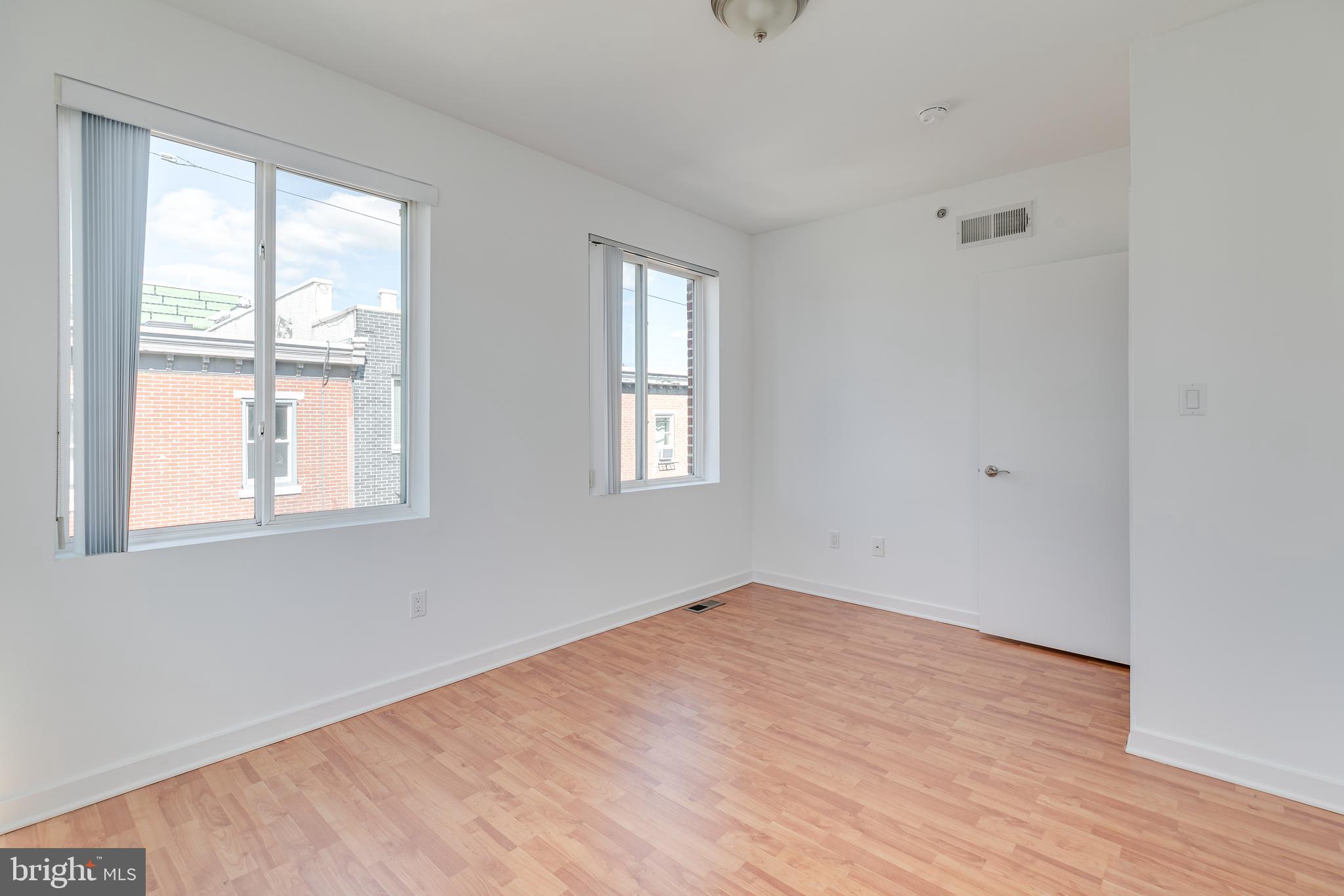 220 West George Street, Unit 224 Philadelphia, PA 19123 - Photo 32 of 56 an empty room with wooden floor and windows