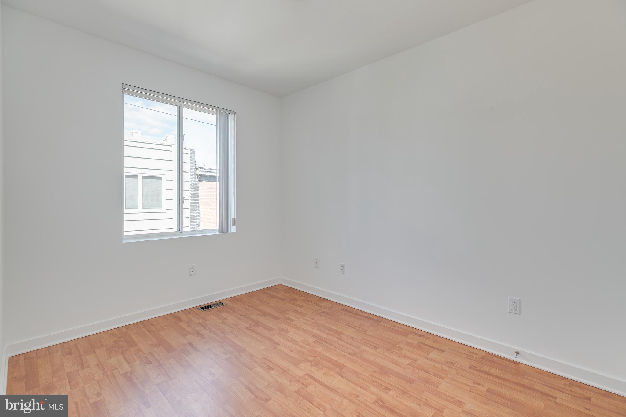 220 West George Street, Unit 224 Philadelphia, PA 19123 - Photo 33 of 56 wooden floor in an empty room with a window