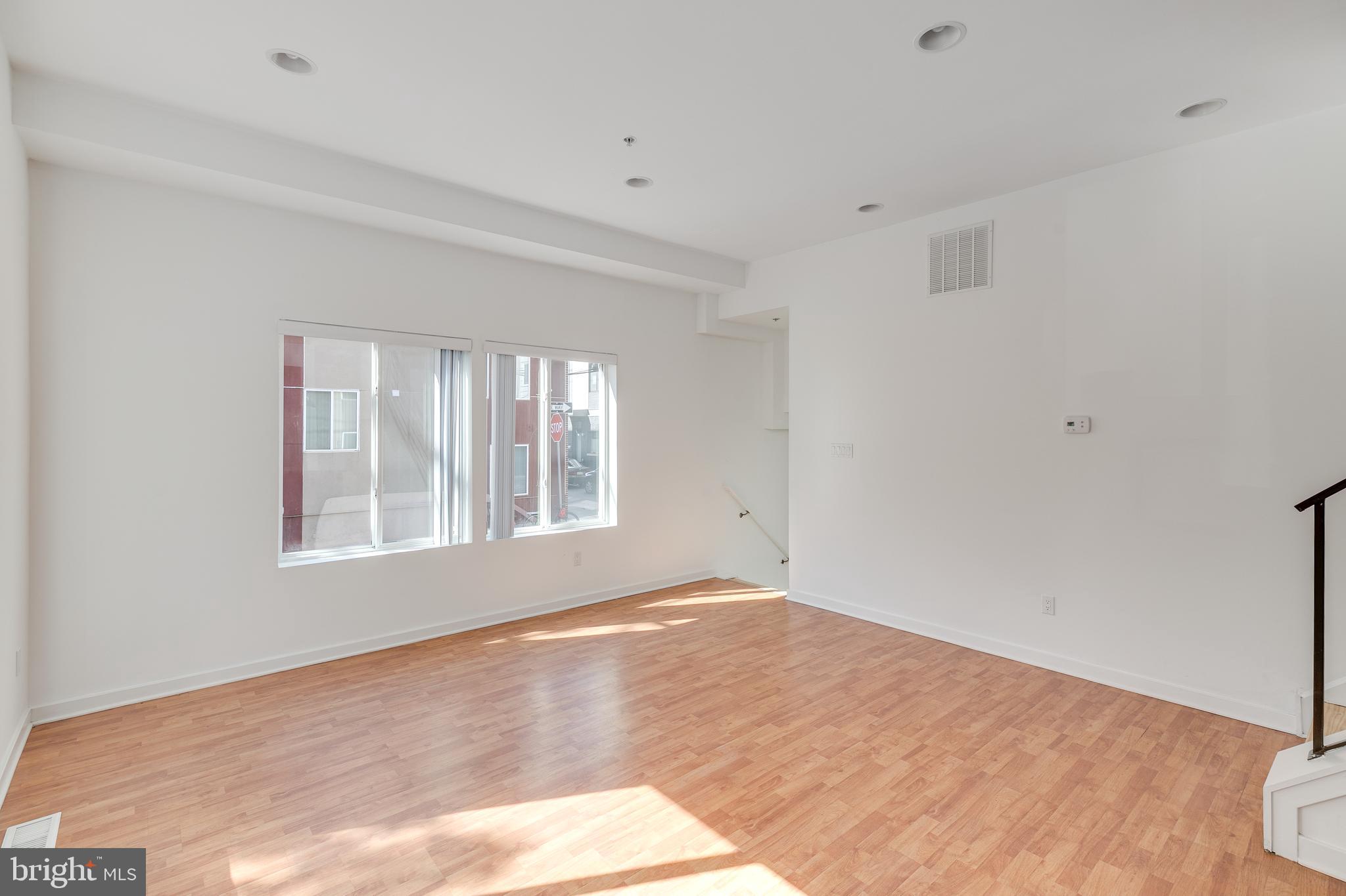 220 West George Street, Unit 224 Philadelphia, PA 19123 - Photo 39 of 56 a view of an empty room with wooden floor and a window