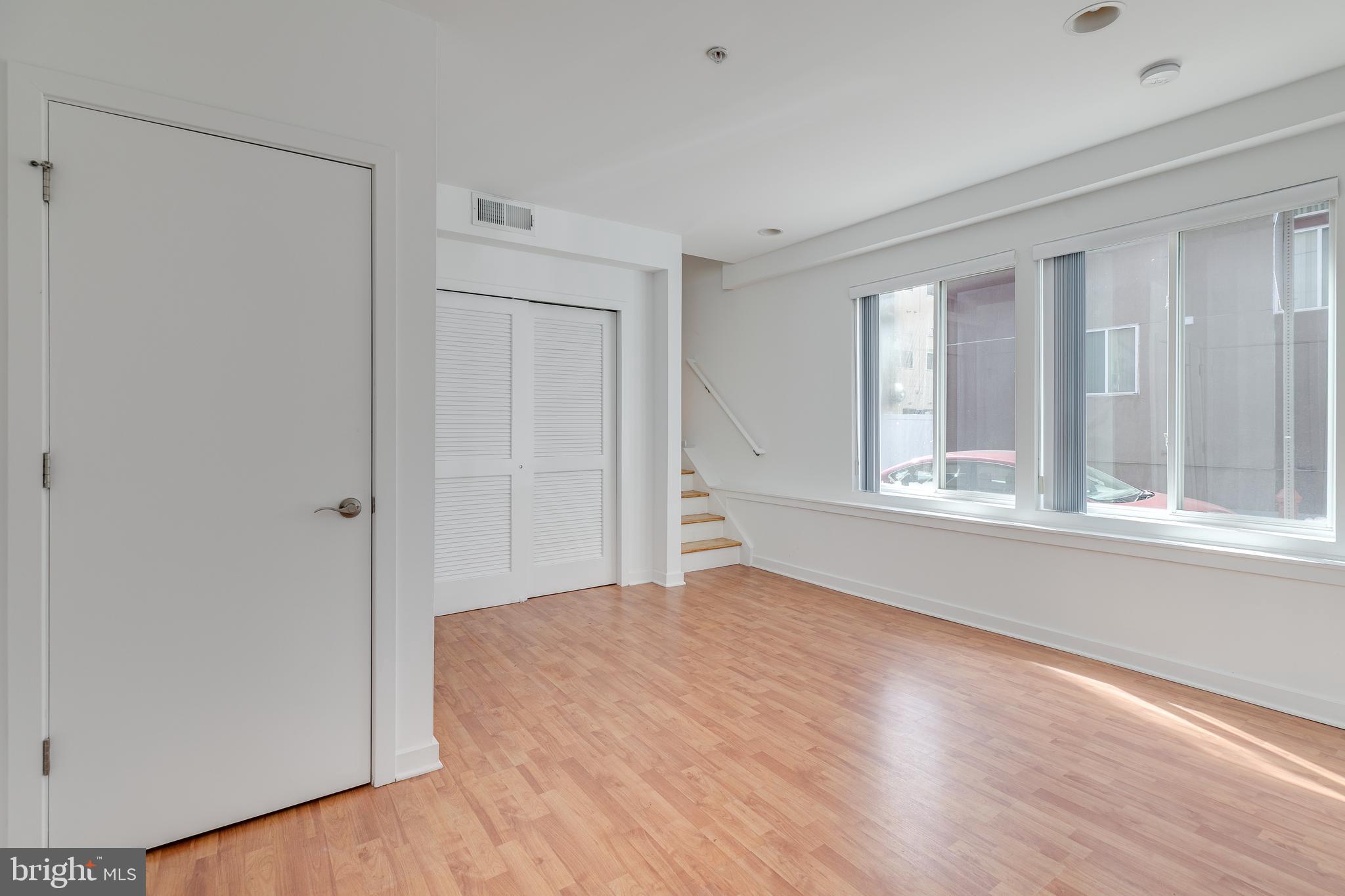220 West George Street, Unit 224 Philadelphia, PA 19123 - Photo 41 of 56 a view of an empty room with wooden floor and a window