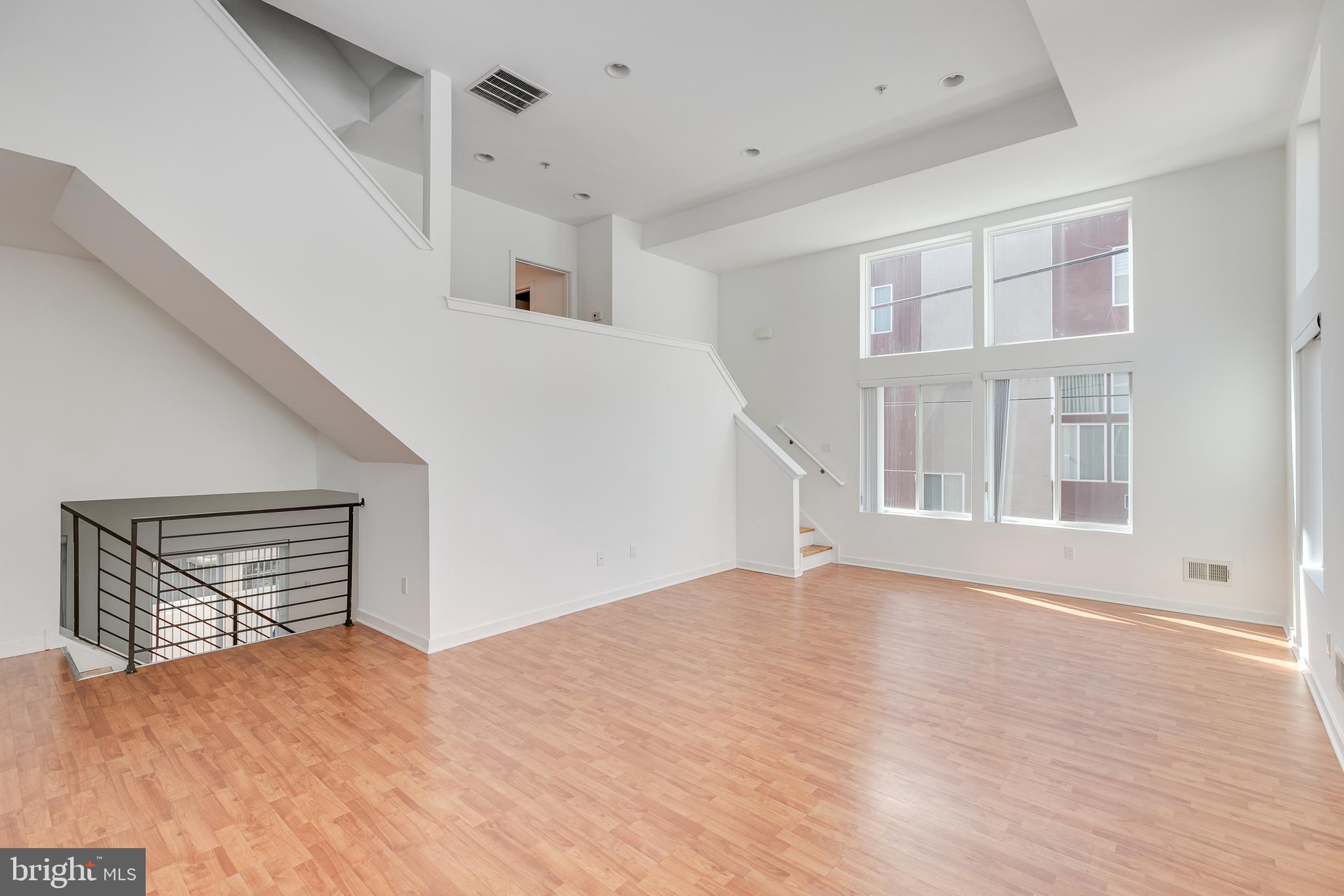 220 West George Street, Unit 224 Philadelphia, PA 19123 - Photo 47 of 56 a view of an empty room with wooden floor and a window