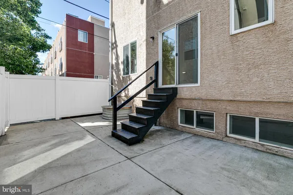 a view of a kitchen with kitchen island a sink a stove and a refrigerator