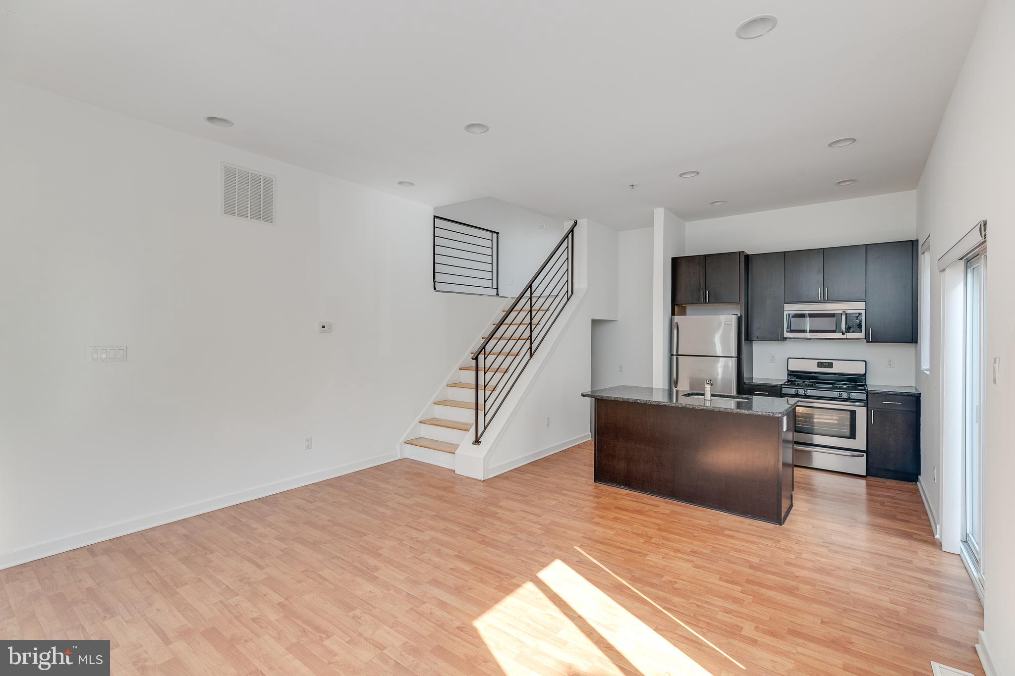 220 West George Street, Unit 224 Philadelphia, PA 19123 - Photo 10 of 56 a view of a kitchen with wooden floor and electronic appliances