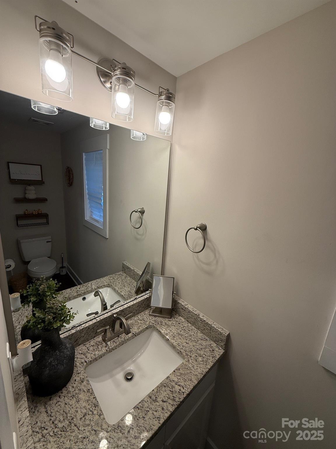 518 Lake Head Road Norwood, NC 28128 - Photo 18 of 20 a bathroom with a granite countertop sink a toilet and shower