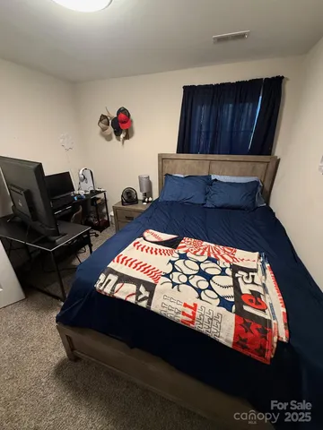 a bed sitting in a bedroom next to a wooden floor