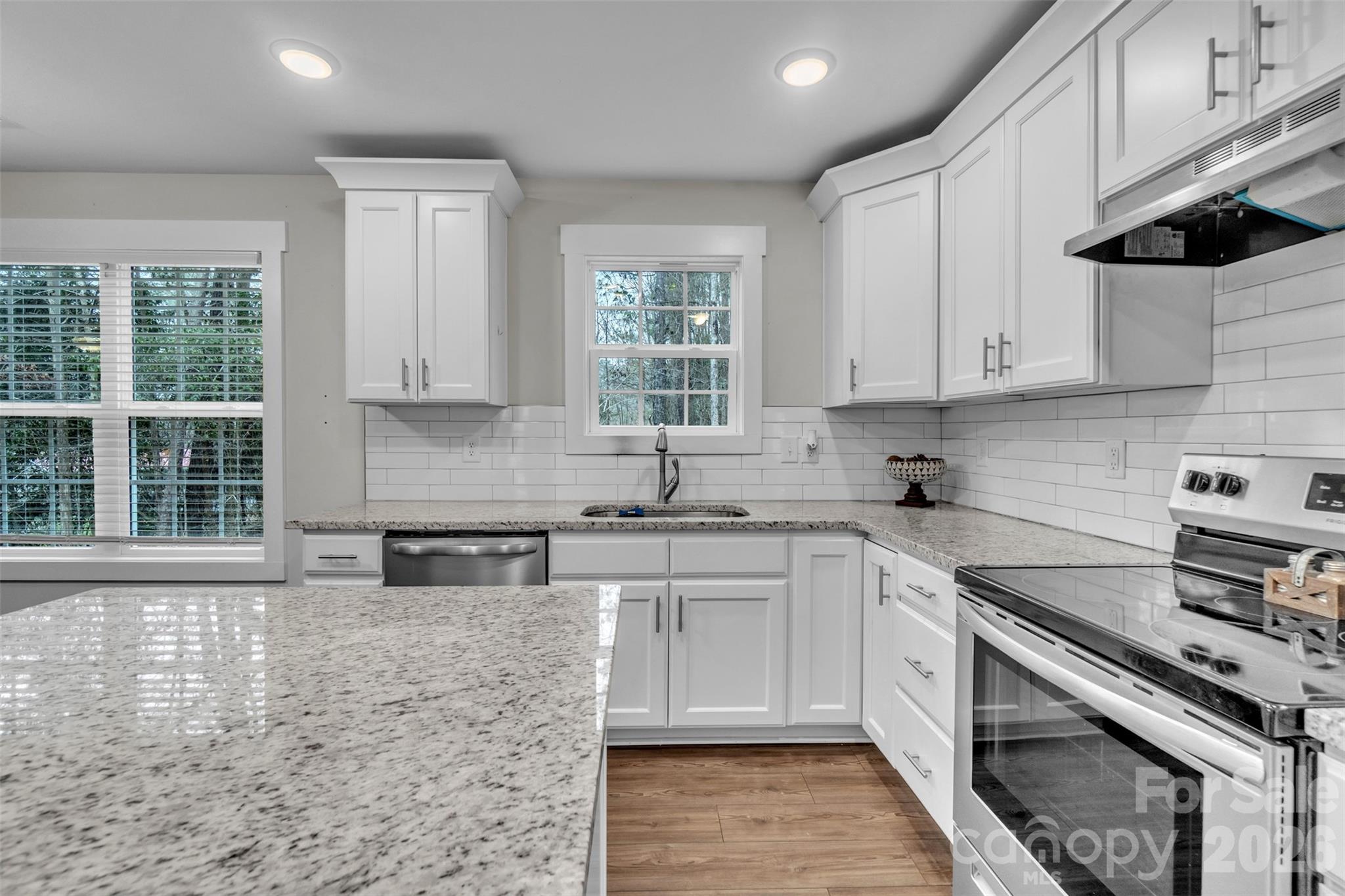 518 Lake Head Road Norwood, NC 28128 - Photo 20 of 39 a kitchen with stainless steel appliances granite countertop a sink a stove a microwave and cabinets