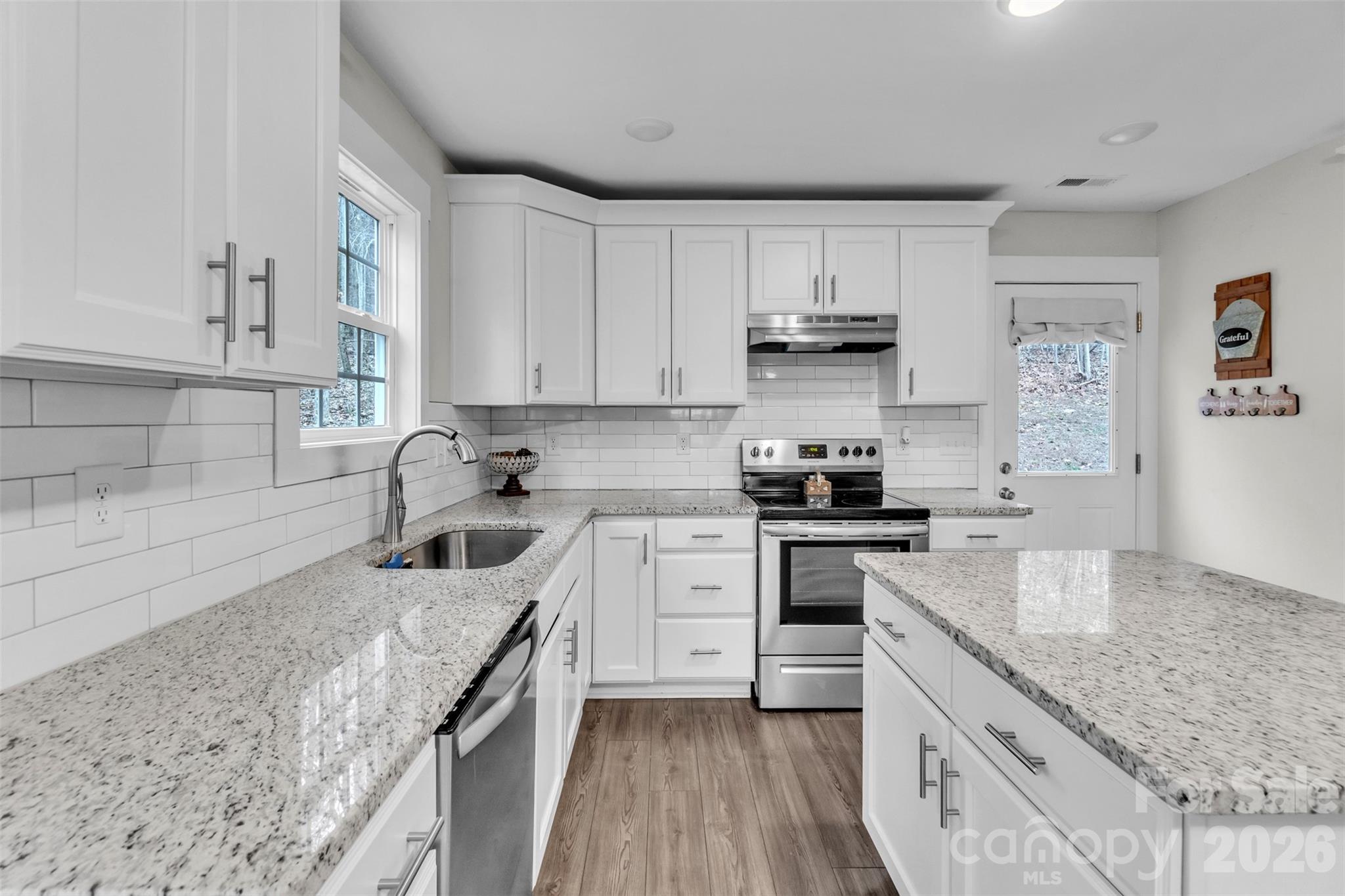 518 Lake Head Road Norwood, NC 28128 - Photo 23 of 39 a kitchen with granite countertop a sink stove and cabinets