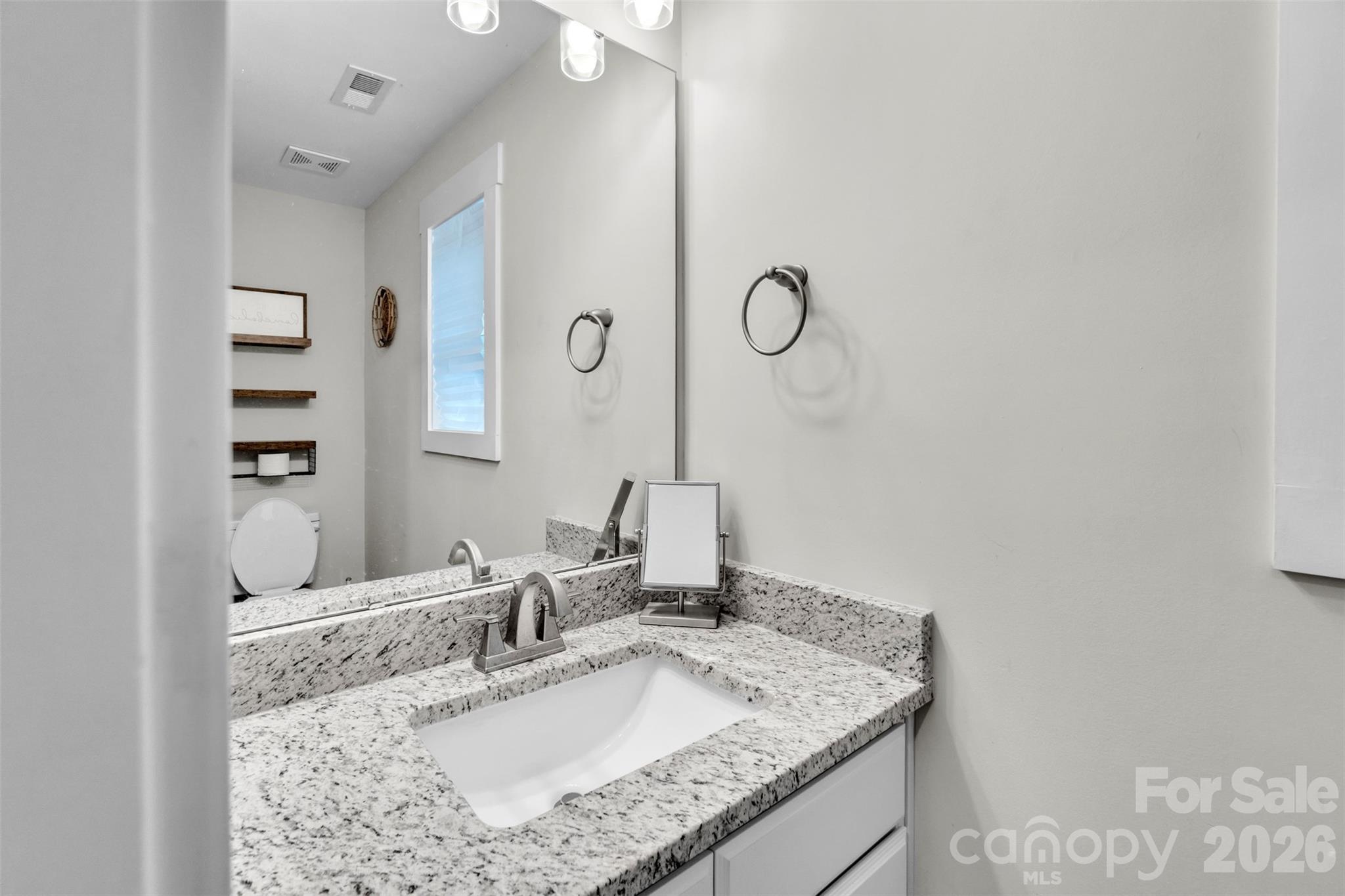 518 Lake Head Road Norwood, NC 28128 - Photo 29 of 39 a bathroom with a granite countertop sink and a mirror
