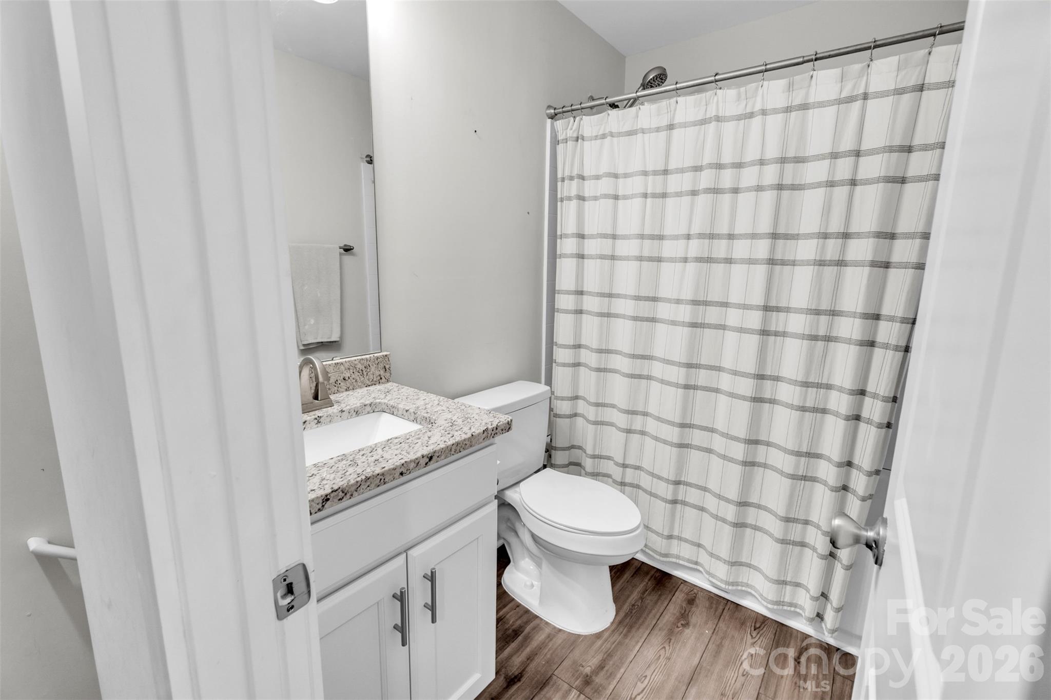 518 Lake Head Road Norwood, NC 28128 - Photo 31 of 39 a bathroom with a granite countertop toilet and a sink
