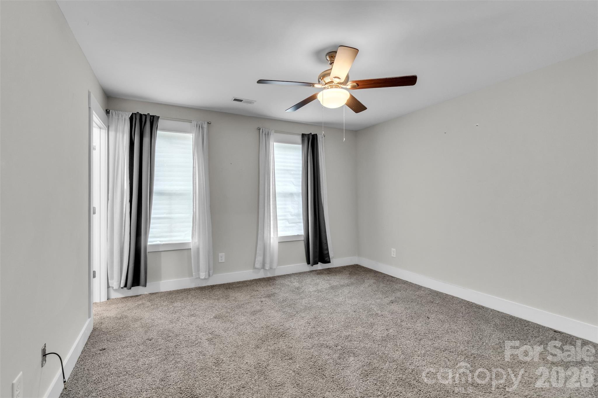 518 Lake Head Road Norwood, NC 28128 - Photo 33 of 39 an empty room with windows and fan