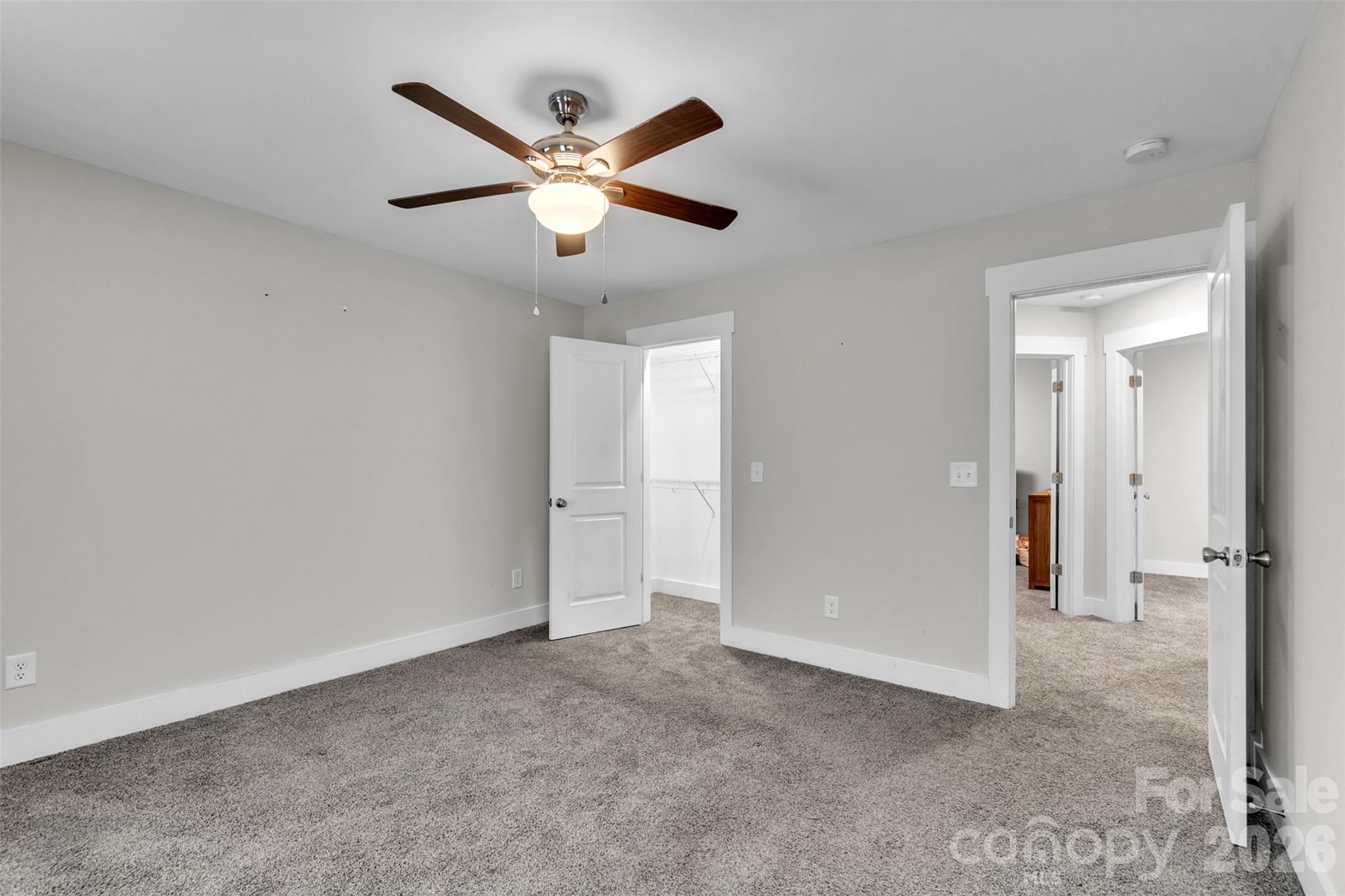518 Lake Head Road Norwood, NC 28128 - Photo 34 of 39 an empty room with closet and a chandelier fan