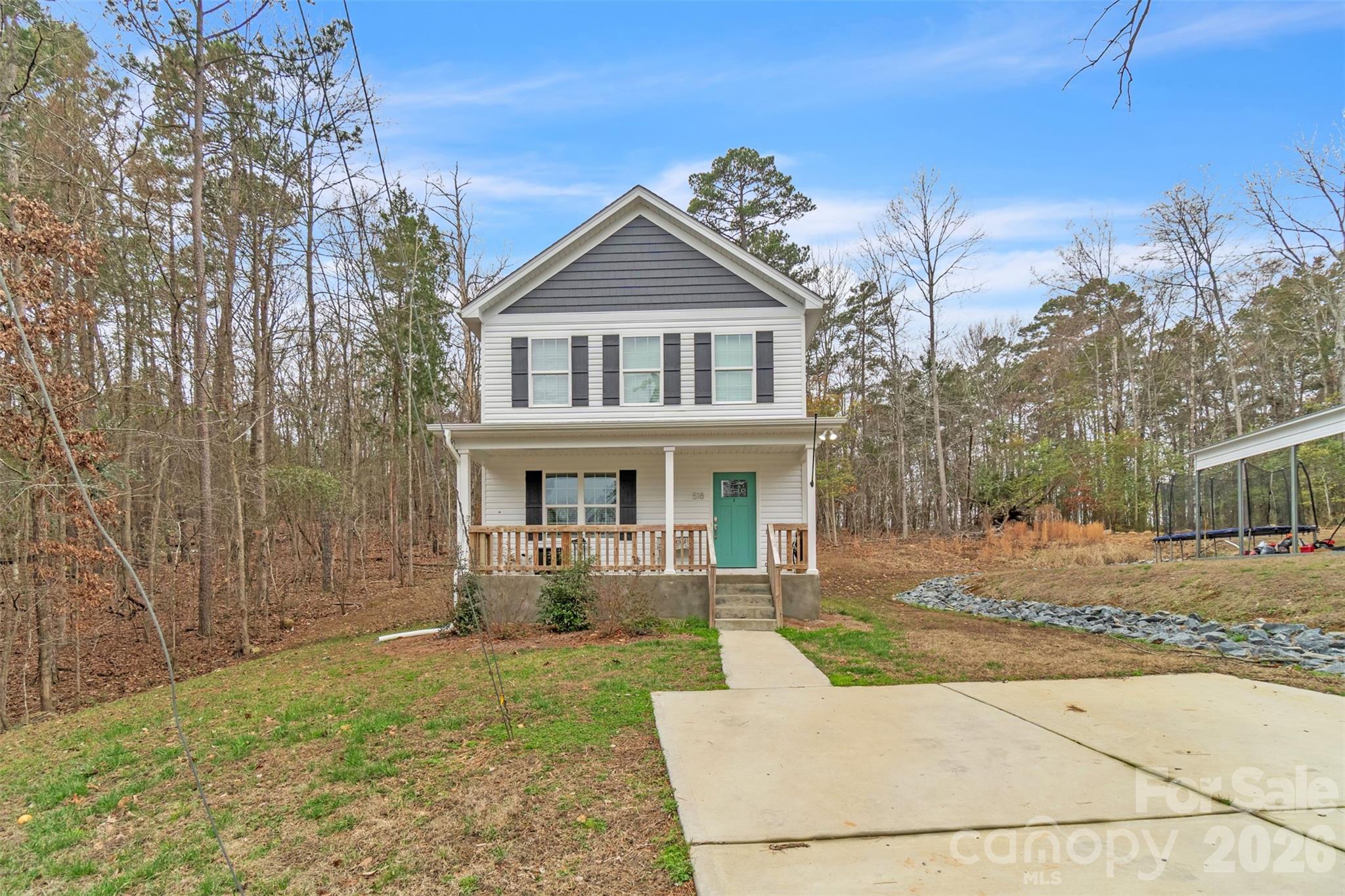 518 Lake Head Road Norwood, NC 28128 - Photo 5 of 39 a front view of a house with garden
