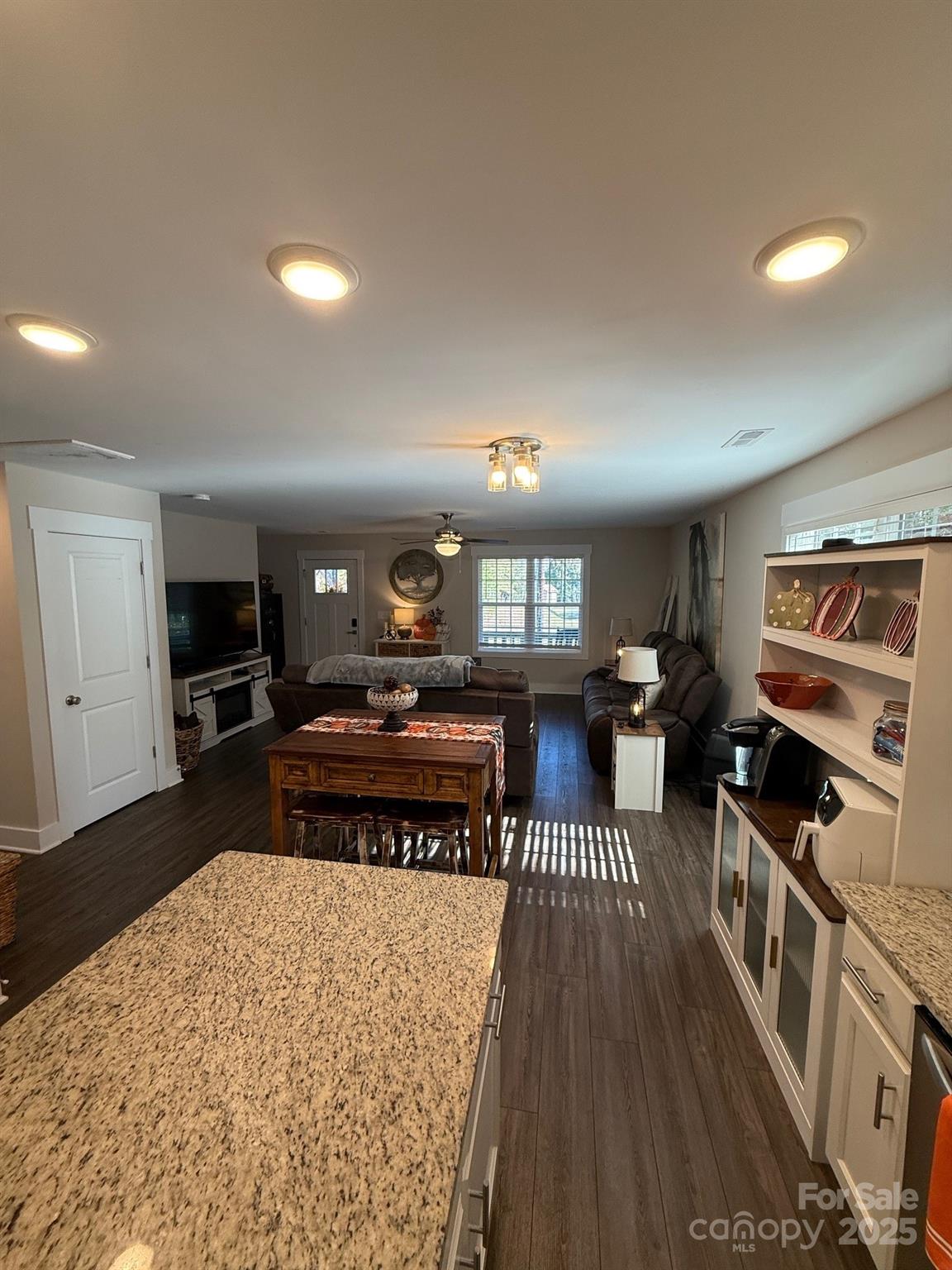 518 Lake Head Road Norwood, NC 28128 - Photo 5 of 20 a living room with furniture a flat screen tv and kitchen view