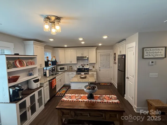 a kitchen with refrigerator and stove