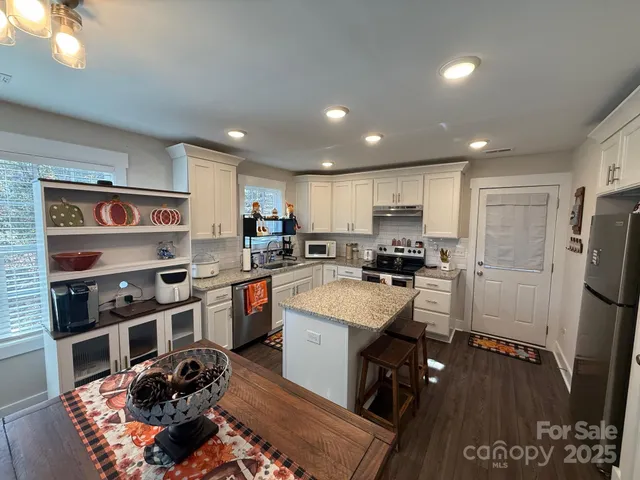 a kitchen with refrigerator and cabinets