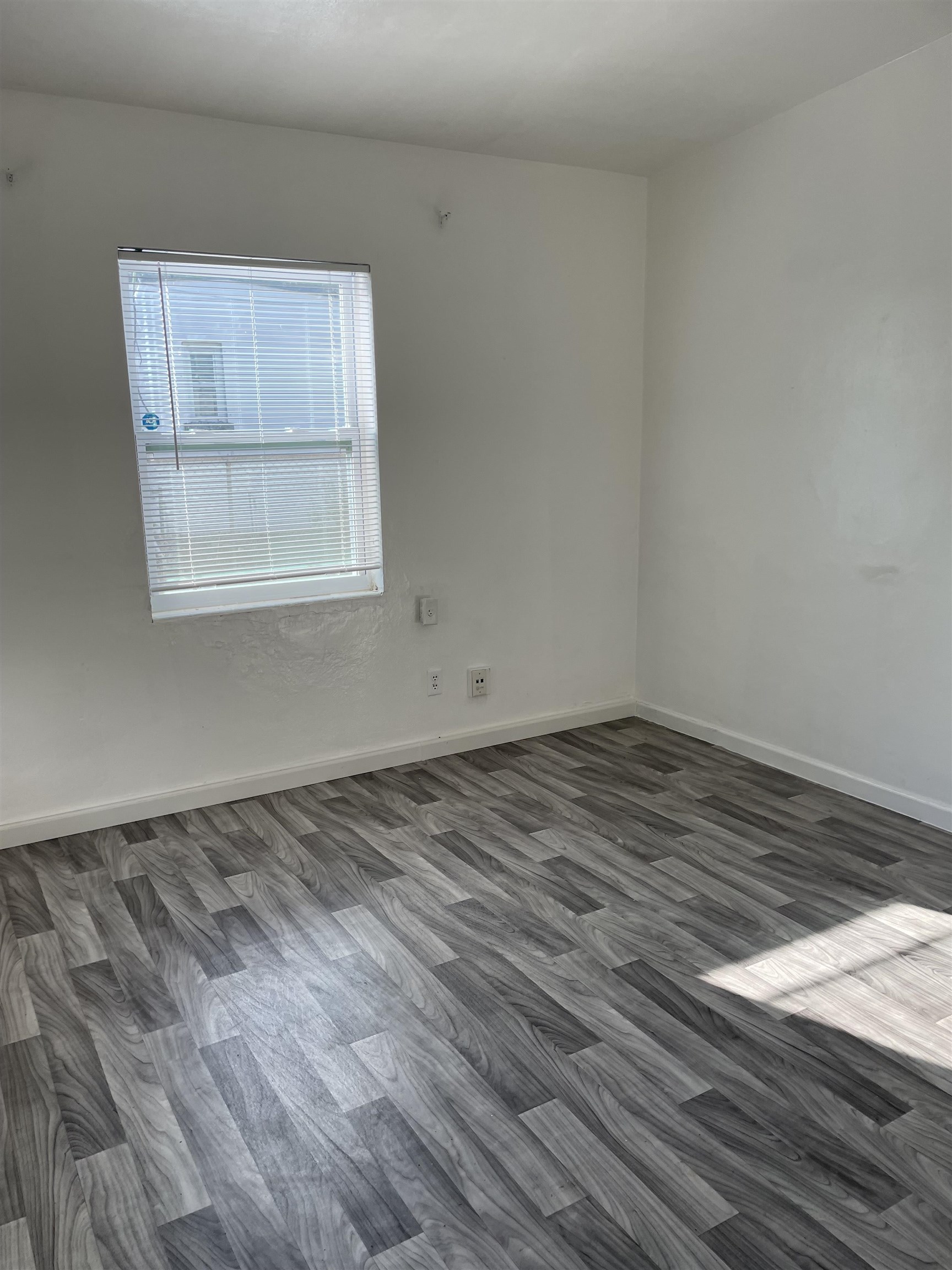6 Christopher Street St. Augustine, FL 32084 - Photo 12 of 14 an empty room with wooden floor and windows