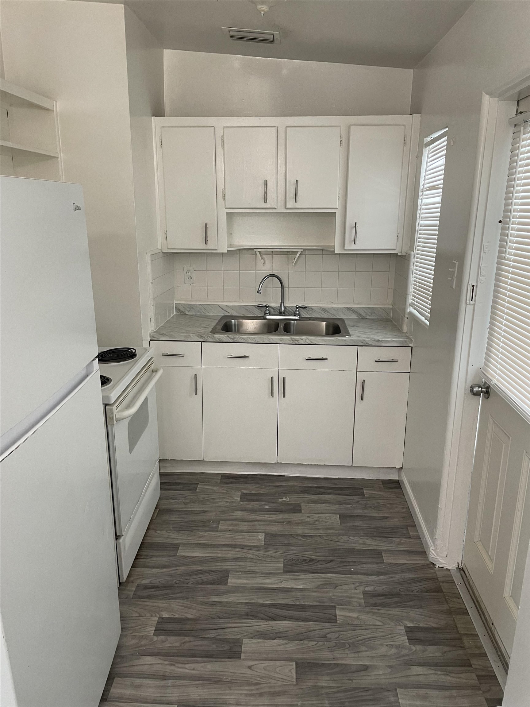 6 Christopher Street St. Augustine, FL 32084 - Photo 7 of 14 a kitchen with a sink a stove oven and white cabinets