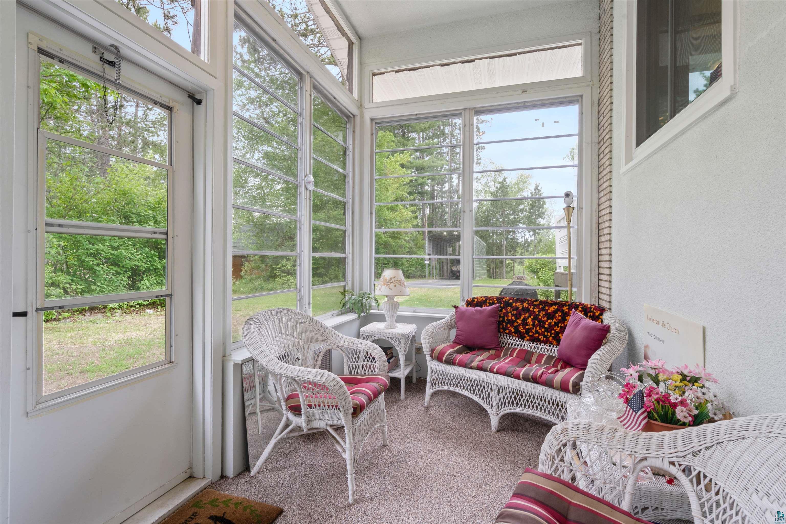 3975 Long Lake Shores Road Eveleth, MN 55734 - Photo 12 of 52 Enclosed sunroom featuring multiple large windows