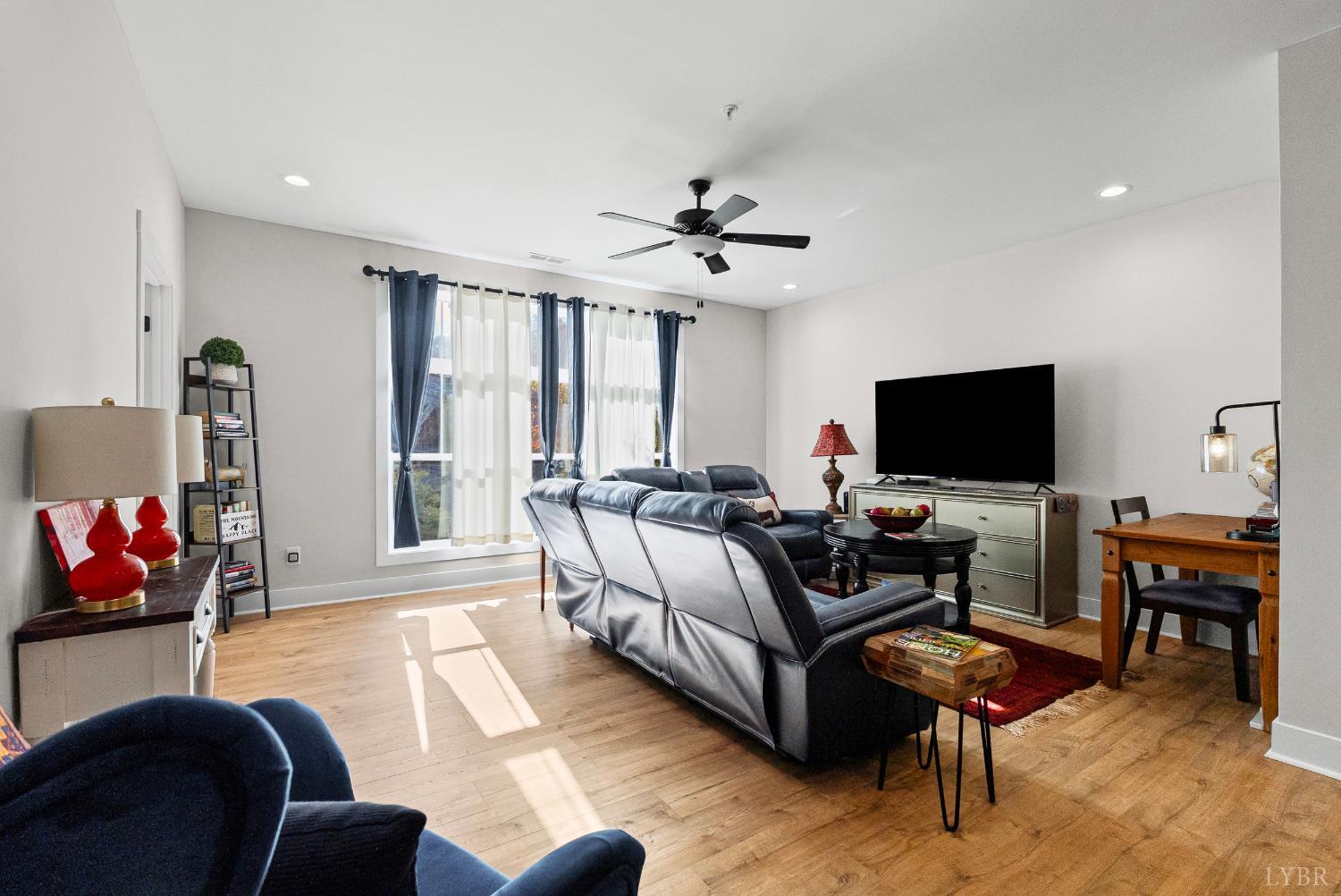 1301 Stoney Ridge Boulevard, Unit 105 Forest, VA 24551 - Photo 18 of 31 a living room with furniture and a flat screen tv