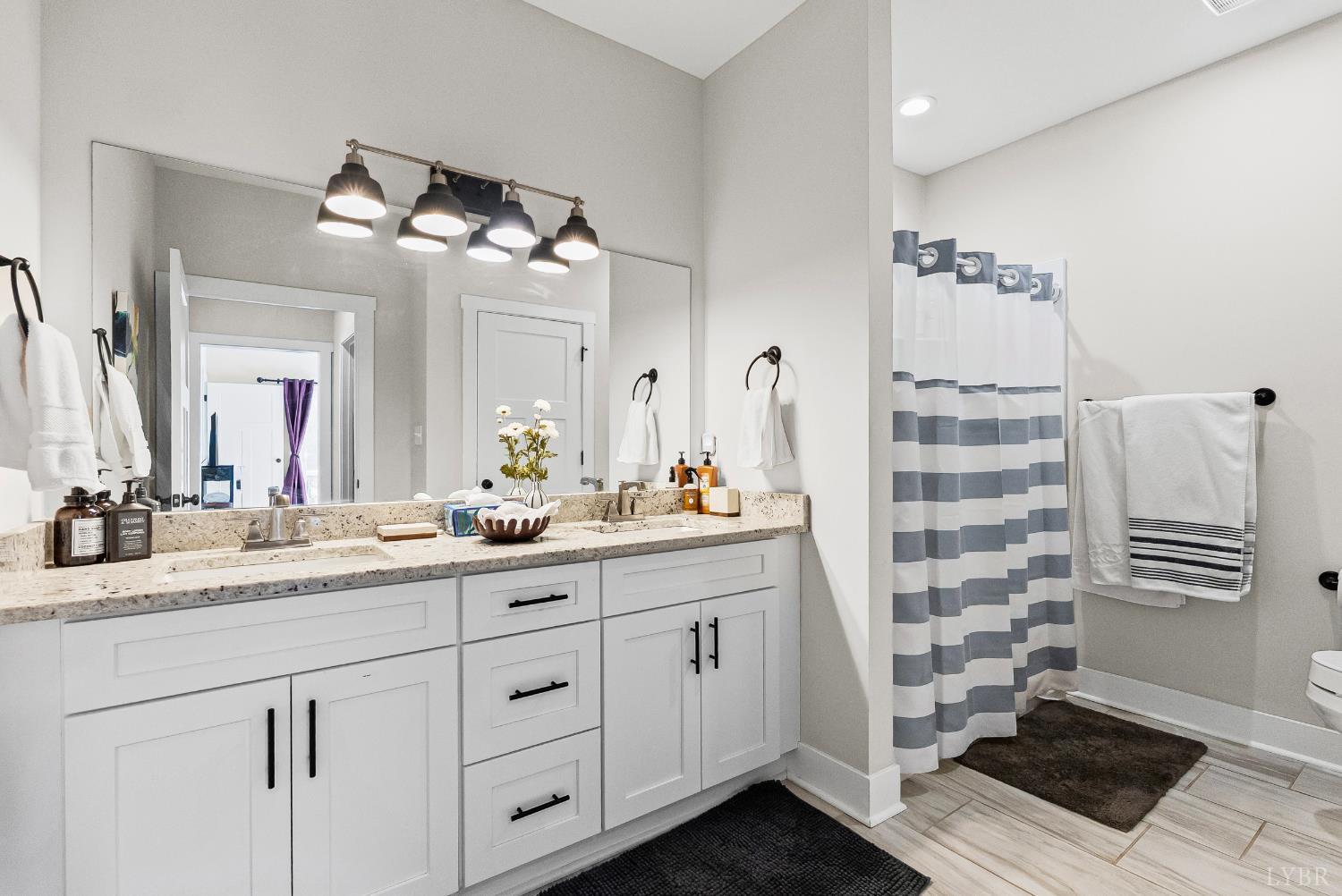 1301 Stoney Ridge Boulevard, Unit 105 Forest, VA 24551 - Photo 24 of 31 a bathroom with a sink double vanity and a mirror