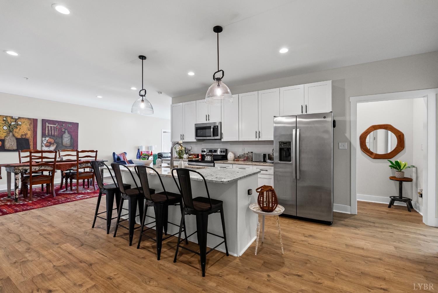1301 Stoney Ridge Boulevard, Unit 105 Forest, VA 24551 - Photo 7 of 31 a kitchen with stainless steel appliances granite countertop a dining table chairs refrigerator and cabinets