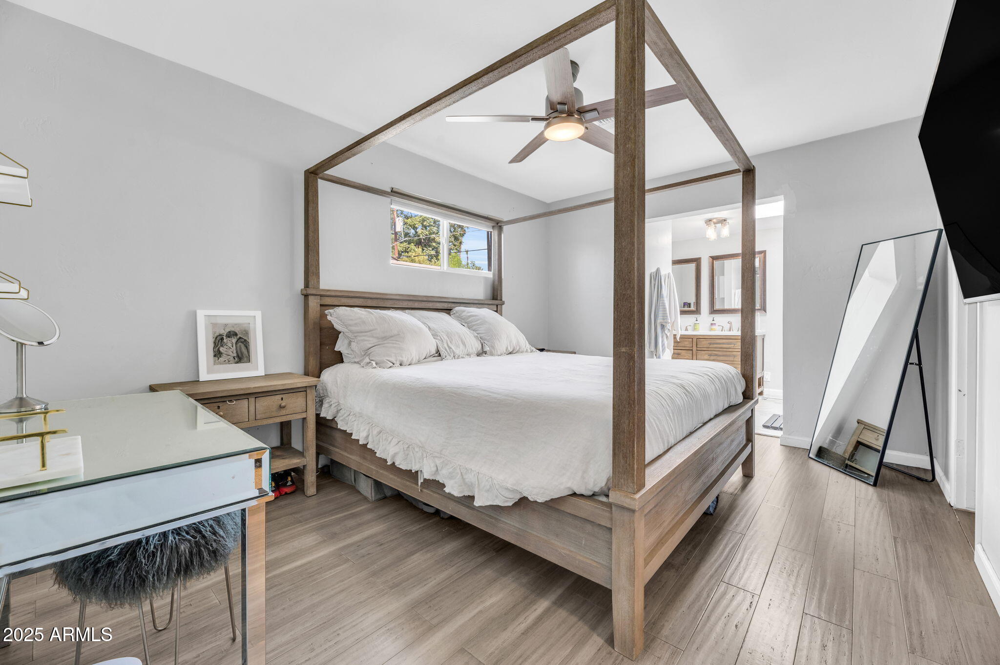 4928 East Palm Lane Phoenix, AZ 85008 - Photo 8 of 17 a bedroom with a bed a mirror and a desk