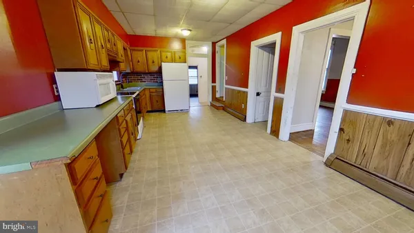 a view of a kitchen with furniture and staircase